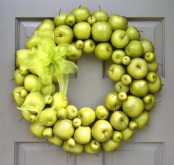a bright green apple wreath with a matching sheer bow looks bold and will accent your front door a lot