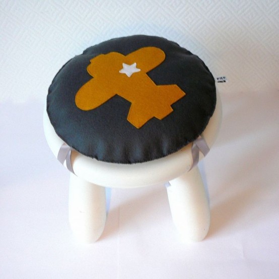 a white IKEA Mammut stool with an airplane cushion on top is a creative idea for a boy's room