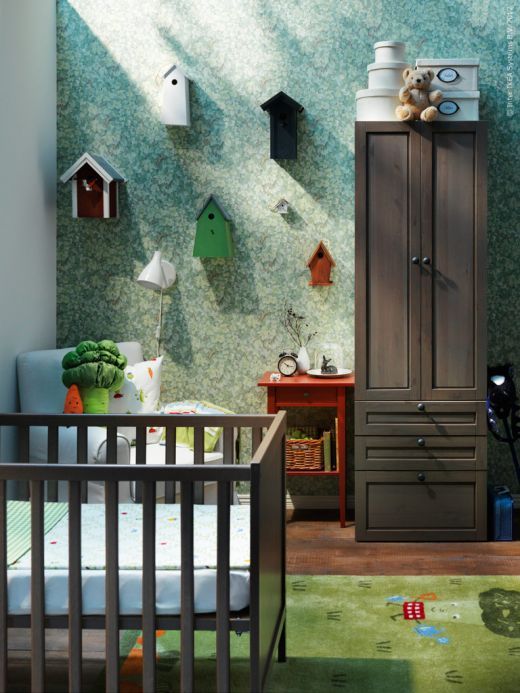 a whimsy nursery with dark stained furniture, an IKEA Sundvik crib, blue and green touches and whimsy decor