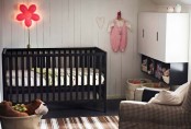 a monochromatic nursery with copper touches and a black IKEA Sundvik crib plus neon lights
