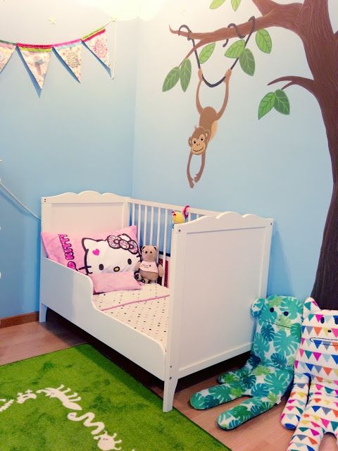 a fun and colorful nursery in blues and greens, a white Sundvik bed and colorful toys and pillows