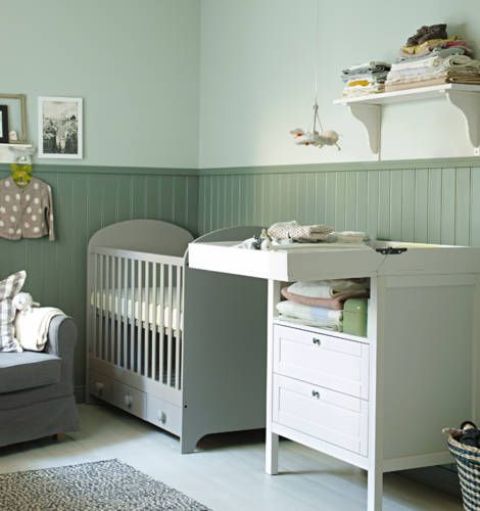 a pastel green nursery with white touches, comfy furniture, an IKEA Sundvik crib and a very relaxing ambience