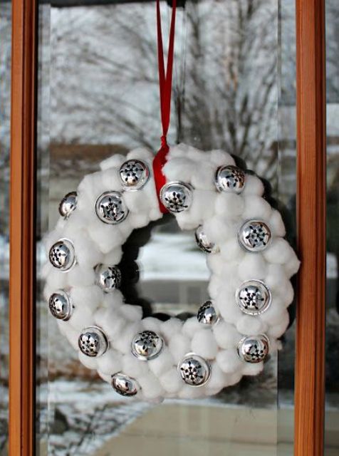 a snowball and bell Christmas wreath on a red ribbon is a lovely outdoor Christmas decoration