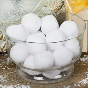 a clear bowl filled with snowballs is a pretty winter centerpiece or decoration to rock