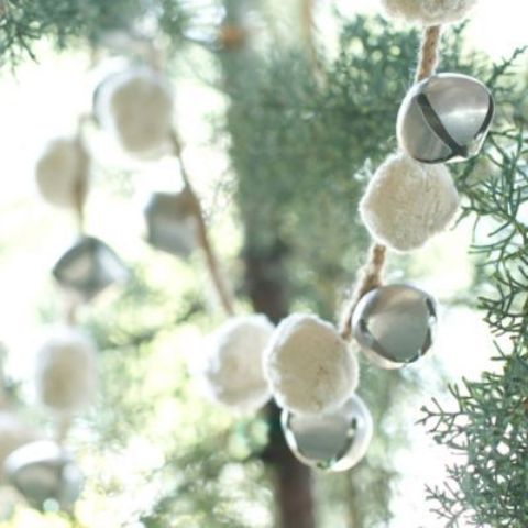 a chic snowball and bell garland will make the space look cool and very Christmassy and you can easily DIY it
