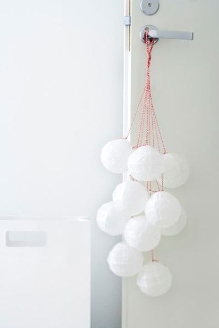 snowballs hanging on the door are a cool and cute way to add a winter feel to the space
