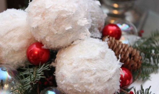 winter decor with snowballs, fir twigs, pinecones and mini red ornaments is a lovely winter decoration or centerpiece