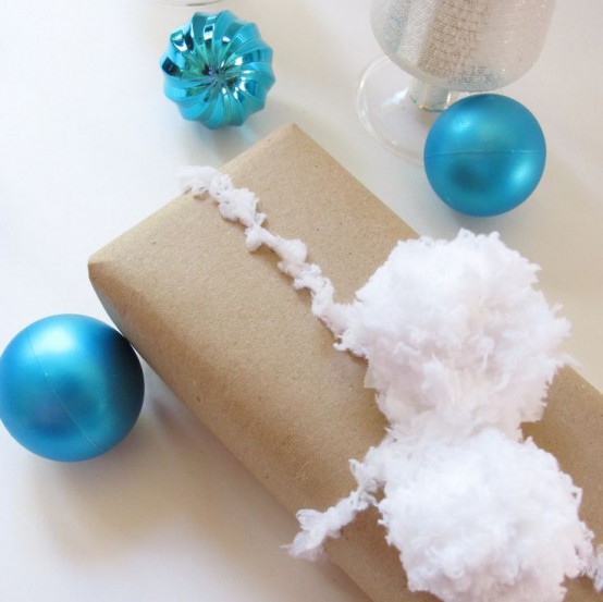 gifts wrapped in kraft paper and with fluffy snowballs added to the top are lovely and very cool