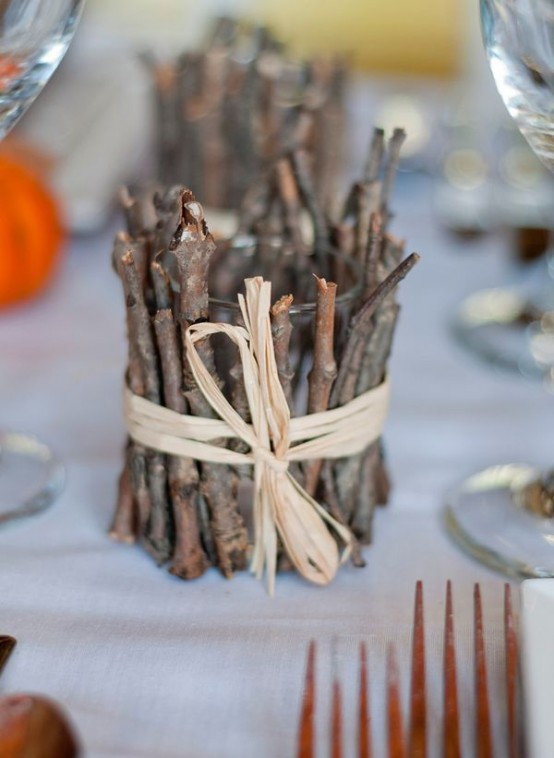 a candleholder covered with sticks and twigs is a cool decoration for woodland or rustic touch