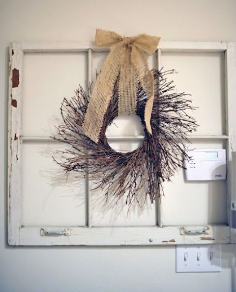a twig and stick fall wreath with a burlap bow is a cool and easy decoration that will last long