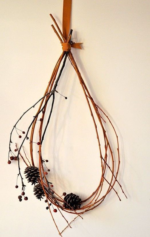a simple and all natural fall decoration   a twig or branch wreath with berries and pinecones is very easy and fast to make