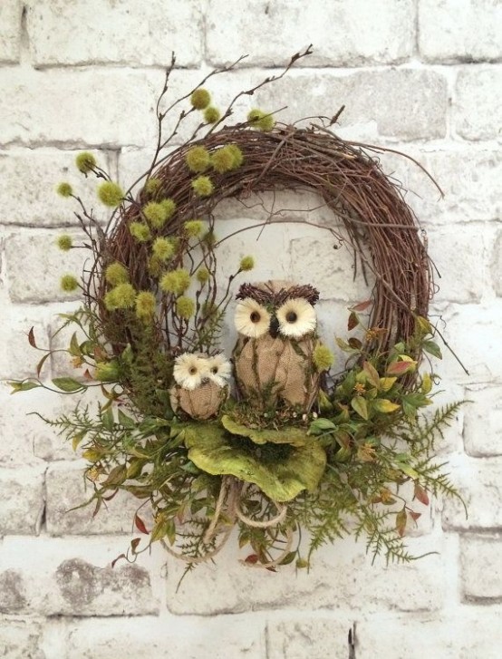 a fall woodland wreath of vine with twigs, greenery, faux leaves and owls is a nice nature-inspired decoration