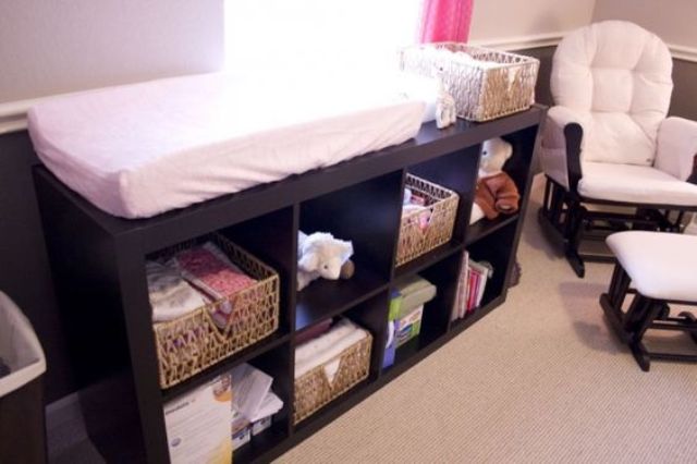 a dark stained changing table with open storage compartments is a very functional idea