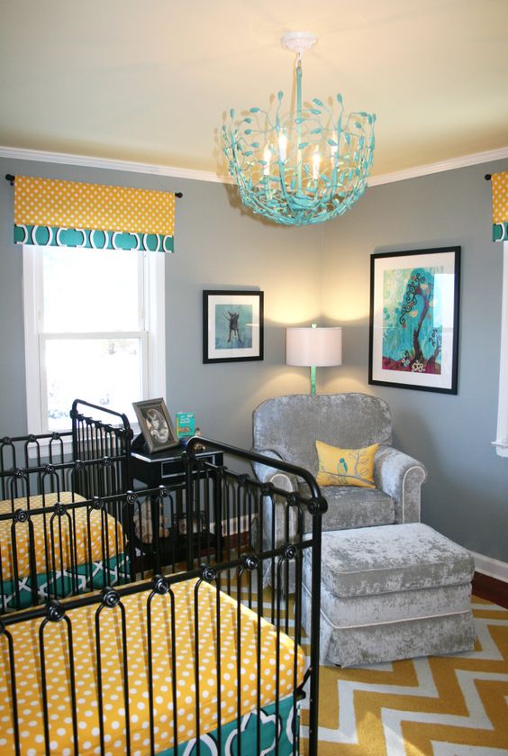 a bright shared nursery with grey walls, touches of turquoise and yellow, black forged cribs and printed linens