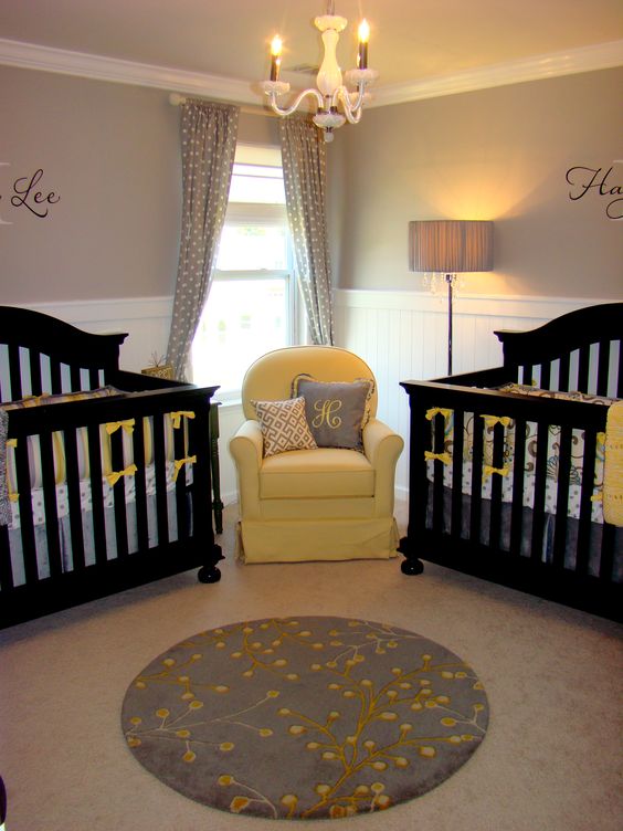 an elegant rustic nursery in white and dove grey, with black furniture, grey polka dot curtains and a yellow chair plus yellow accents all over