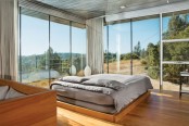 a stylish mid-century modern bedroom with glazed walls is centered around the views that inspire and look fantastic and curtains allow to make it private