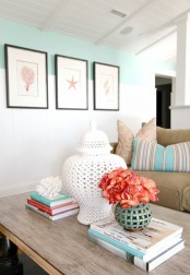 corals on books and a mini gallery wall including corals are lovely decorations for coastal and seaside interiors