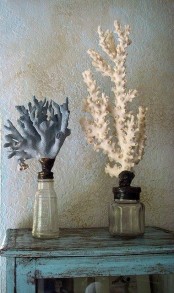 coral home decor – corals placed into bottles and painted white and blue look bold and very cool