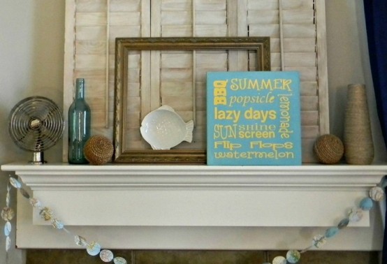 a seashell garland, rope balls, artworks and a blue and yellow beach sign for a simple and bright beach mantel
