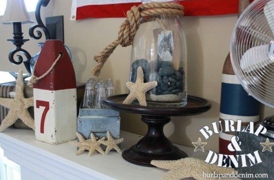 a nautical beach mantel with starfish, a jar with pebbles, rope, color block and striped bottles and candle holders