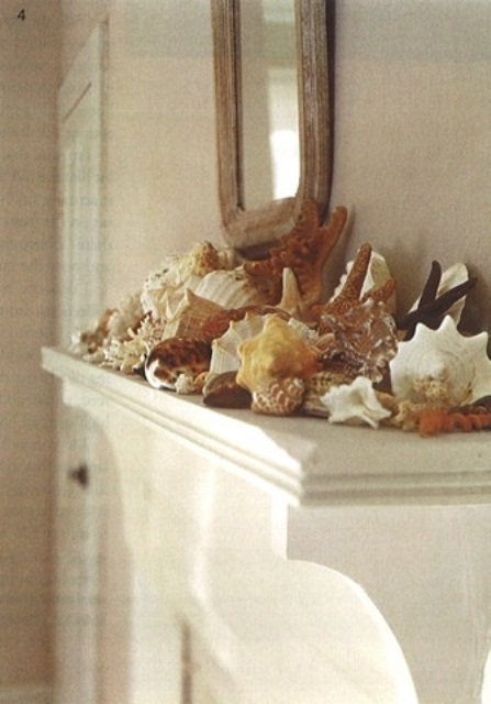 a mantel with lots of seashells and a mirror over it is a simple way to bring a beachy feel to your space