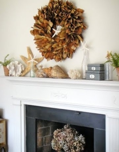 seashells, corals, starfish, some blooms and a dried leaf wreath over the mantel to make it look beachy yet fall-infused