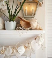 a giant seashell, corals and a garland of seashells and starfish will make your mantel very beach-like and holiday-inspired