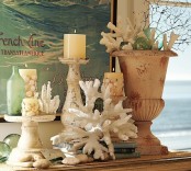 a coral, candle in candleholders, touches of aqua and blue, a vintage urn for a shabby chic beach mantel
