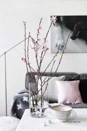 a clear vase with cherry blossom is a stylish decoration even for a minimalist or modern space