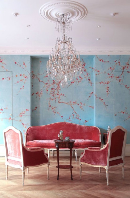 blue walls with cherry blossom decals and matching coral furniture of velvet is a chic idea