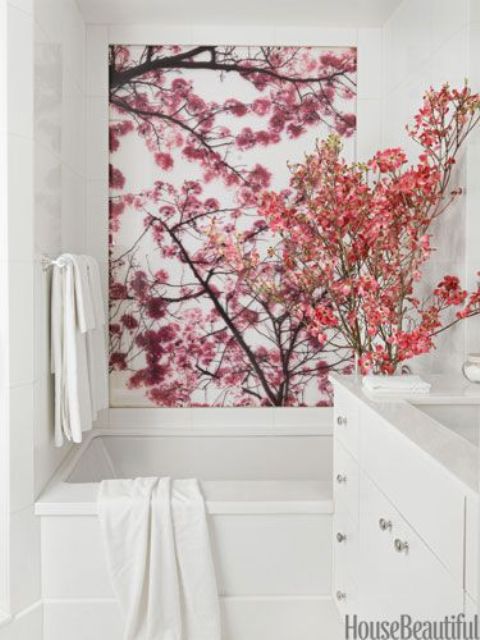 faux pink blooming branches and cherry blossom on the wall to make the bathroom spring-y