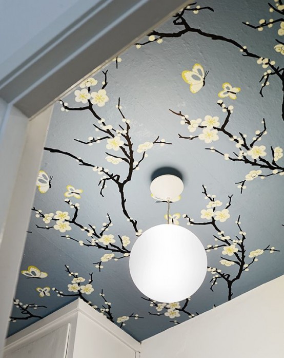 blooming branches on the ceiling make the space feel spring-like and very tender and fresh