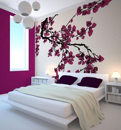 bright cherry blossom decor on the wall brings a strong spring feel to the bedroom and makes it bolder