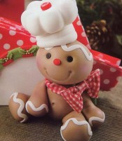 a faux gingerbread man with a burlap scarf and a cook hat is a pretty decoration for a Christmas kitchen