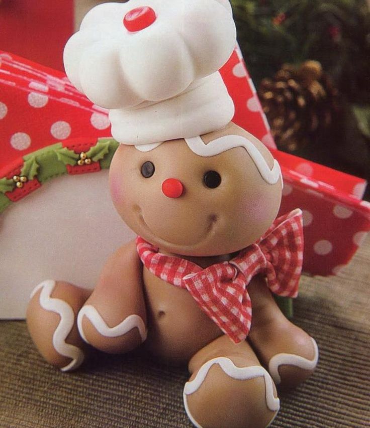 a faux gingerbread man with a burlap scarf and a cook hat is a pretty decoration for a Christmas kitchen