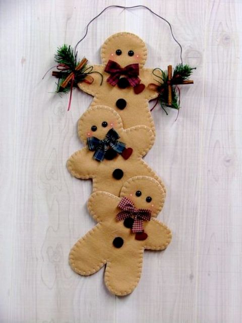 a decoration composed of felt gingerbread men and evergreens is a lovely idea for Christmas decor, it will bring a soft and cozy feel to the space