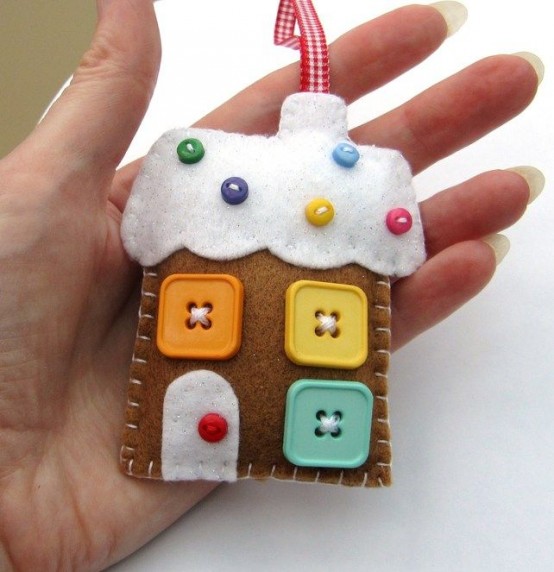 a bright felt gingerbread house with colorful beads and large buttons that portray windows is a gorgeous decoration