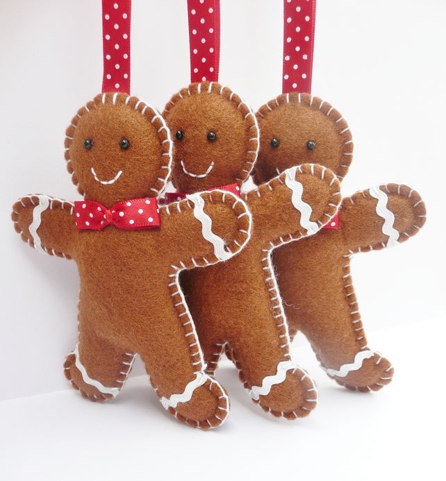 pretty felt gingerbread men with red bows are great Christmas ornaments or just decorations to rock