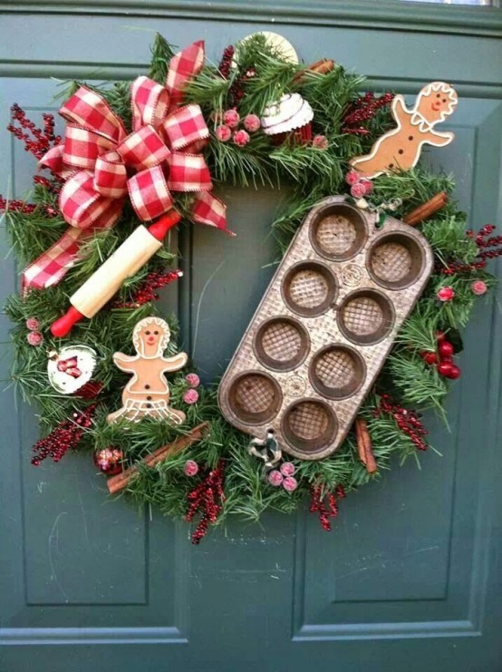 an evergreen Christmas wreath with a red burlap bow, some kitchen items and cinnamon sticks plus felt gingerbread men