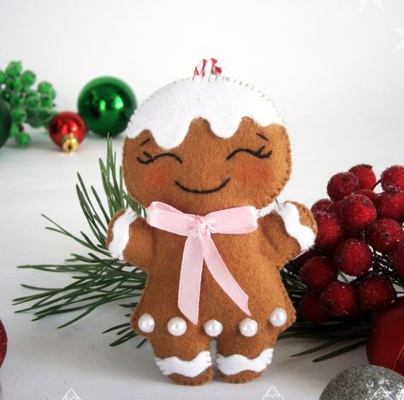 a felt gingerbread girl with beads, a pink bow and glazing as hair is a very cute and fun idea for Christmas decor