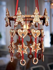 a creative Scandinavian chandelier composed of glazed gingerbread cookies and red ribbon is a very cute and lovely idea to rock