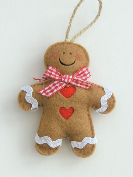 a lovely and cute gingerbread man of felt, with hearts and a scarf is a very cool Christmas ornament or gift tag
