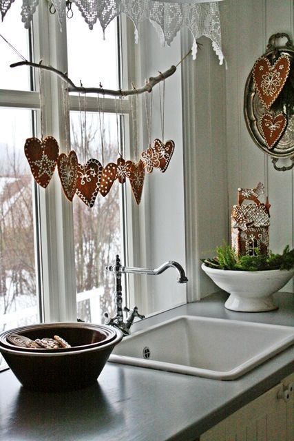 beautiful glazed gingerbread hearts as a garland on the window is a cute idea for a Scandi-inspired Christmas space
