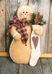 a real oversized Christmas gingerbread cookies with a scarf, a stocking with evergreens and cinnmon sticks is a lovely decoration