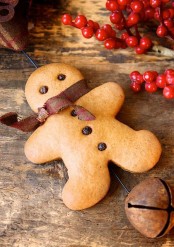 a real gingerbread man with a burlap bow is a tasty cookie and a lovely Christmas decoration
