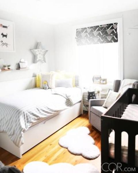a neutral shared space with touches of grey, yellow and a dark wooden crib plus some prints