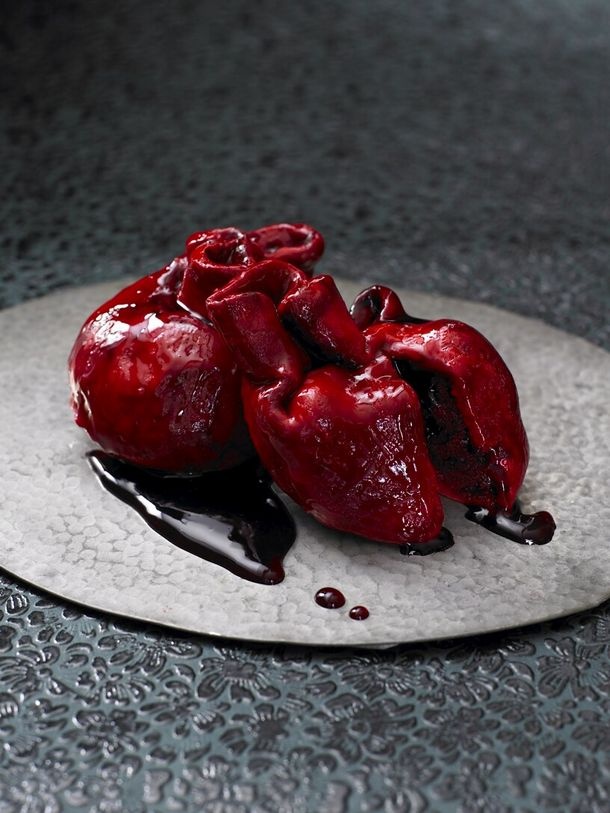 a bloody human heart cake is a bold and scary idea of a Halloween party dessert that you can order to impress everyone