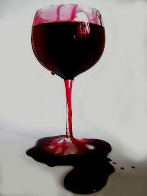 a bloody wine glass decorated with epoxy is a cool and bold idea for a Halloween party, whatever its theme is