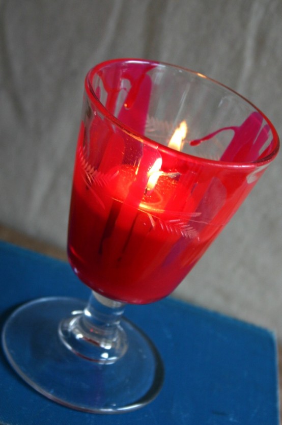 a bloody glass with a red candle is a very cool and bold idea for Halloween decor, it can be used for any Halloween party easily