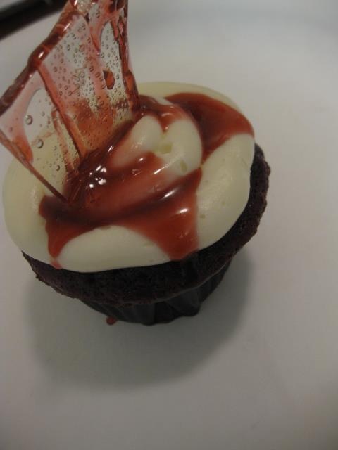 a bloody cupcke with a bloody suga glass shard is a veyr creative and bold treat or favor idea for a Dexter themed Halloween party